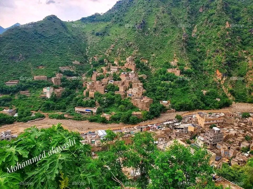 A stunning view of green mountains covered in fog in Yemen