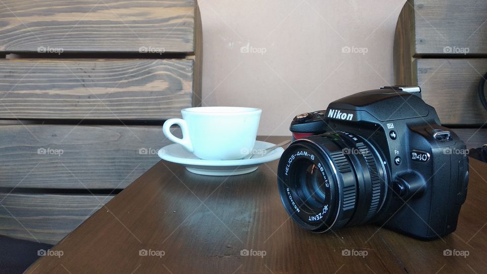 cup of coffee in a cafe and a camera