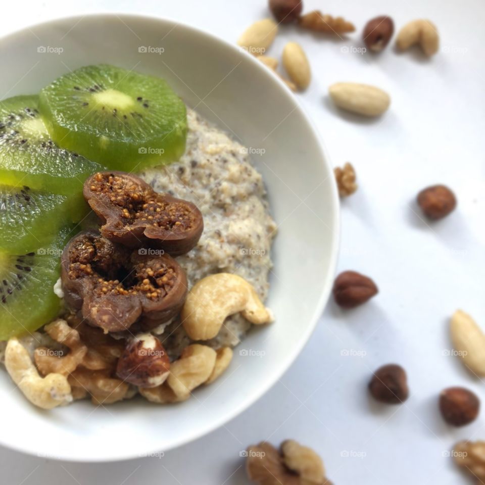 Healthy breakfast of Kiwi fig and nuts on porridge oatmeal 