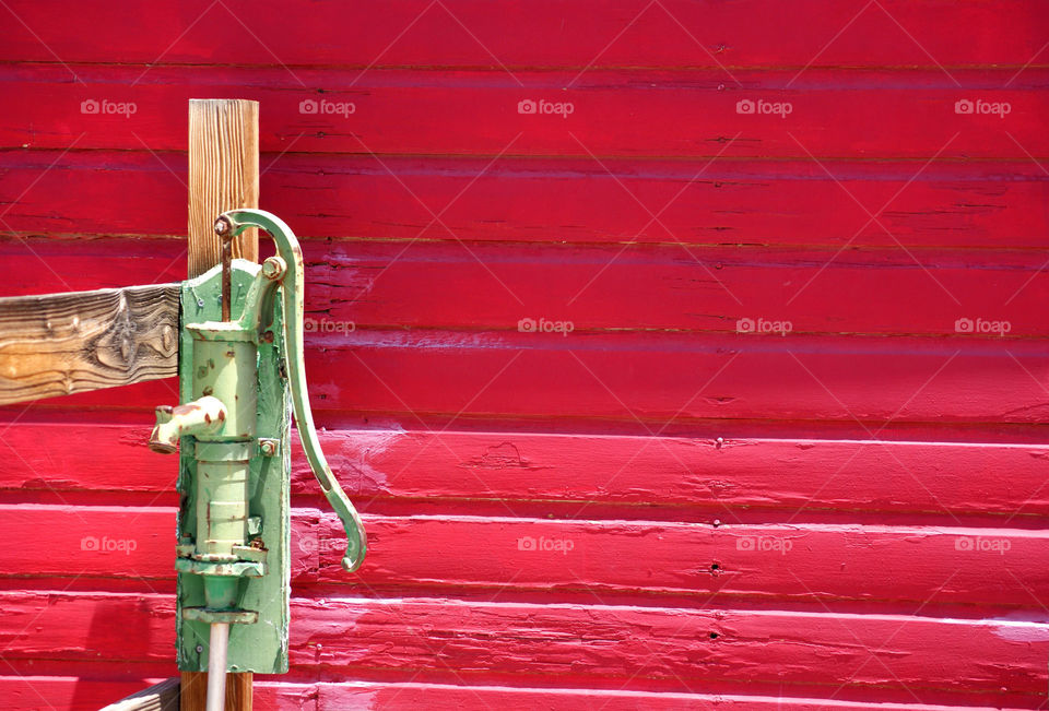 Water pump against red wall