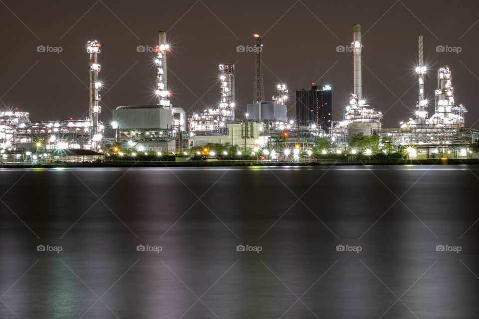 Nice scene of oil refinery light and reflect on the river