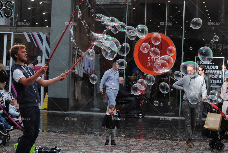 Blowing sop bubles in the Centre of Glasgow. Its AN amazing fun for childrena