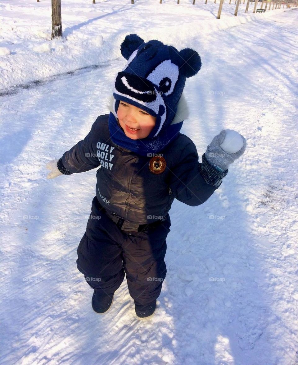 Boy play with snow ball 