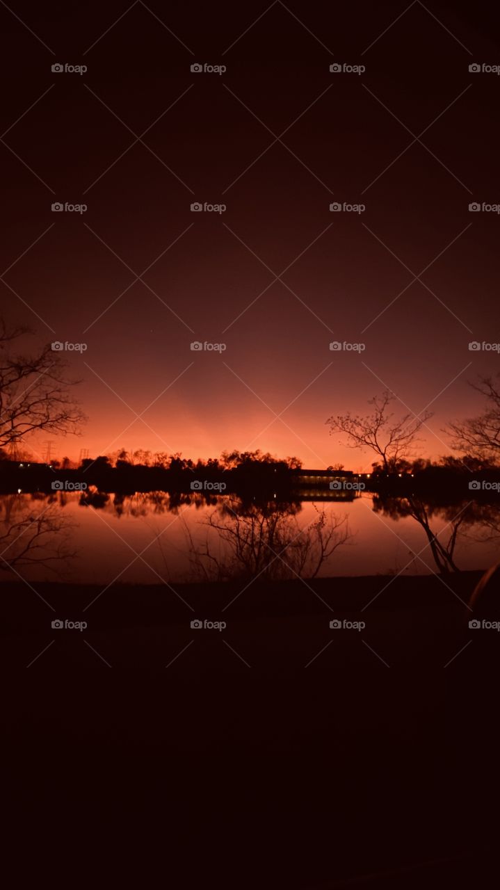Reflections, mirrored image of Lake in beautiful colors. Above the night sky is moving in very close. 