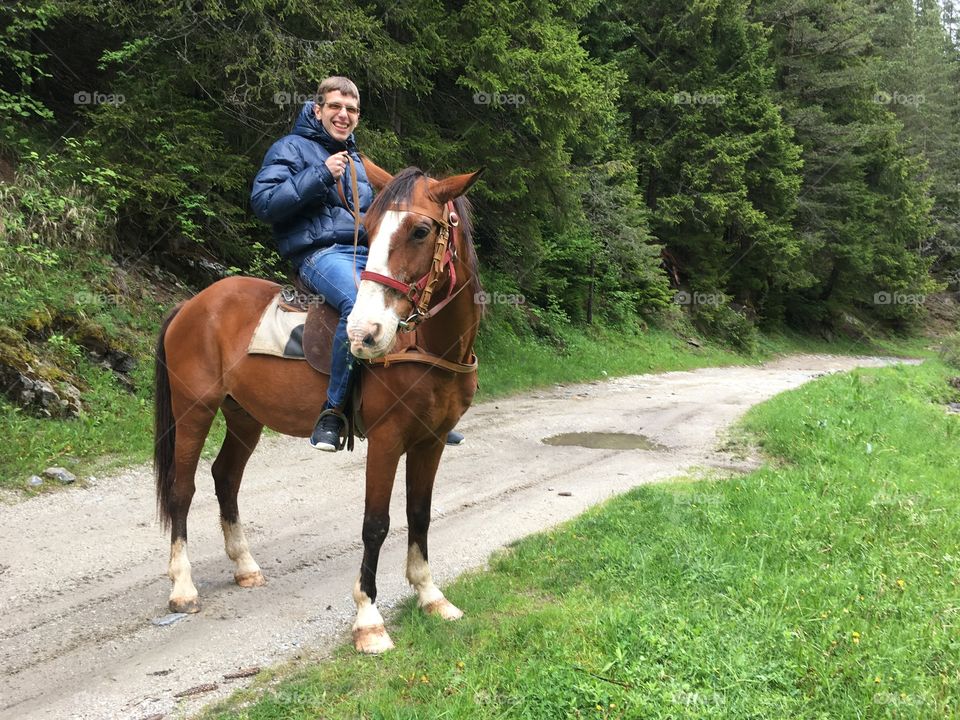 Me riding a horse in the mountains