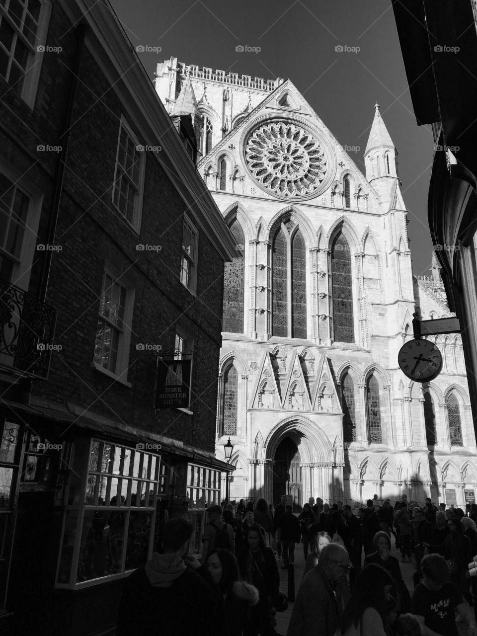 Wonderful York Minster in Black and White ... I like how ONE face in the crowd is lit up by sunlight and the contrast of the street in the shade against the light coloured stone of The Minster.