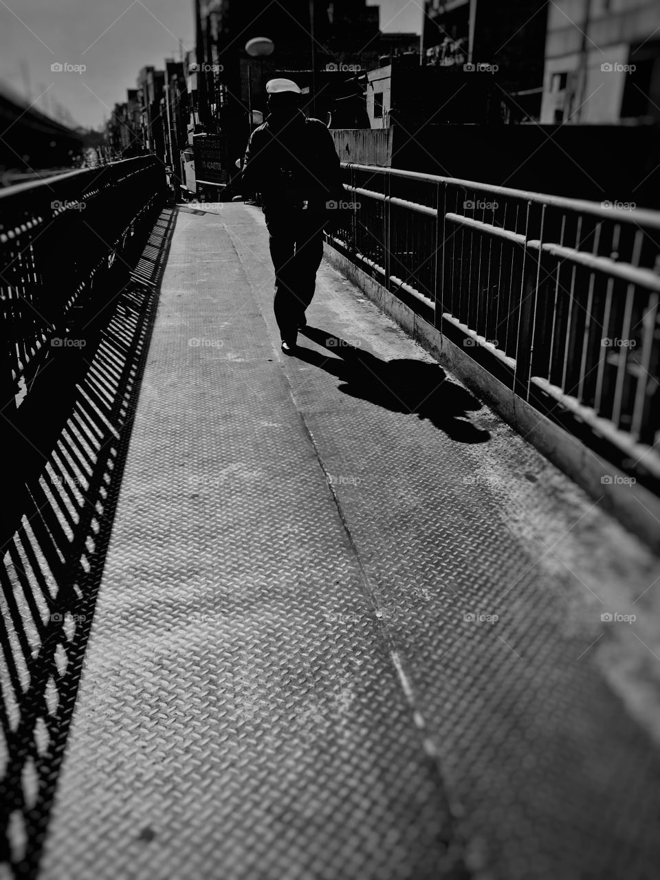 Bnw! City street lige photography! A men just crossed the bridge and i was ready to capture that moment!
