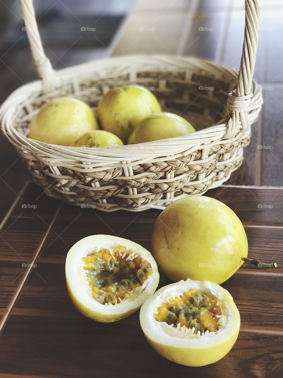 Half-cut passion fruits (Passiflora edulis) in and out of basket