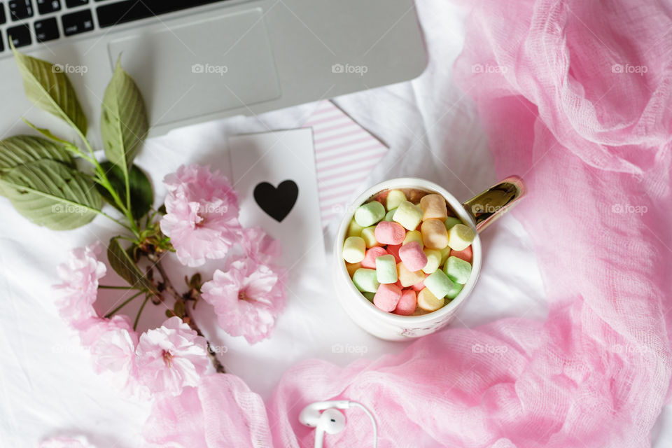 Desktop flatlay with laptop and marshmallow 