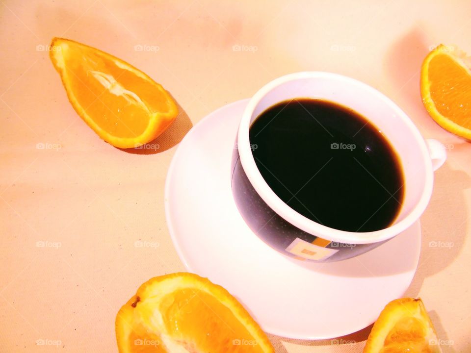 a cup of coffee with orange slices