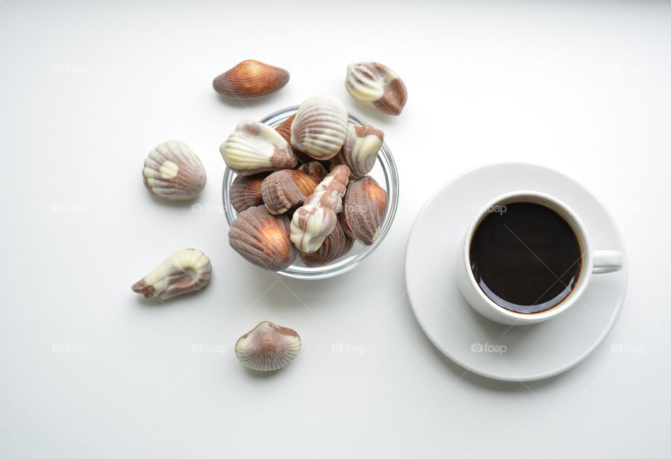 milk chocolate candy and coffee cup white top view background