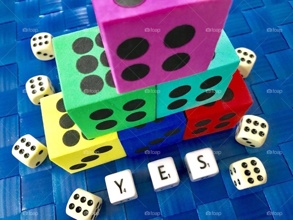 Dices and letters on the table with blue background