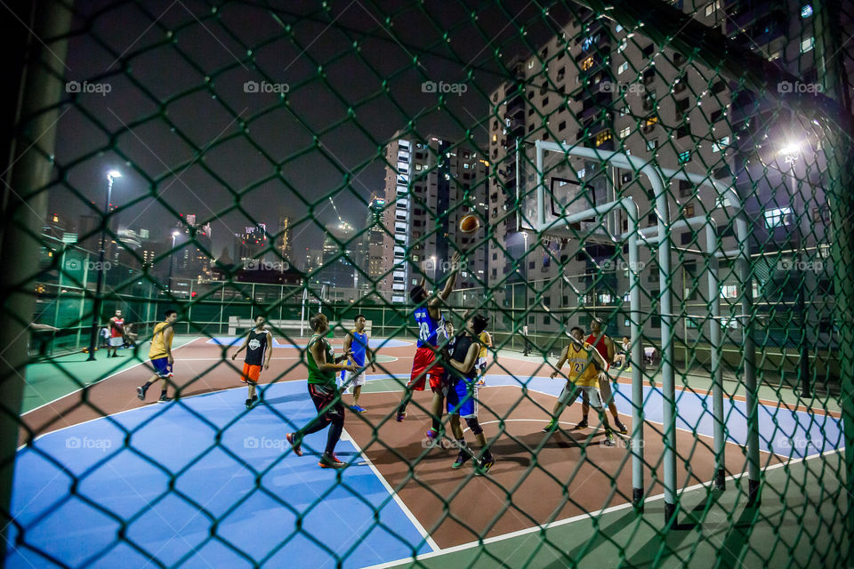 Street basketball at night on a rooftop in Singapore