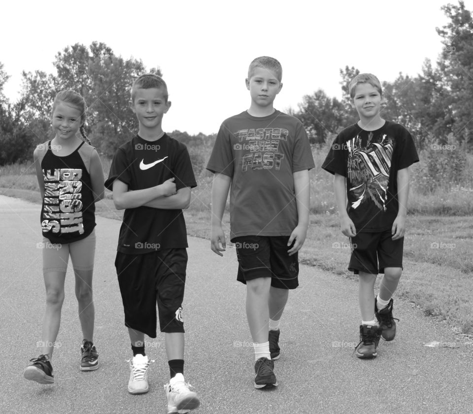 Group of teenager friends walking on road