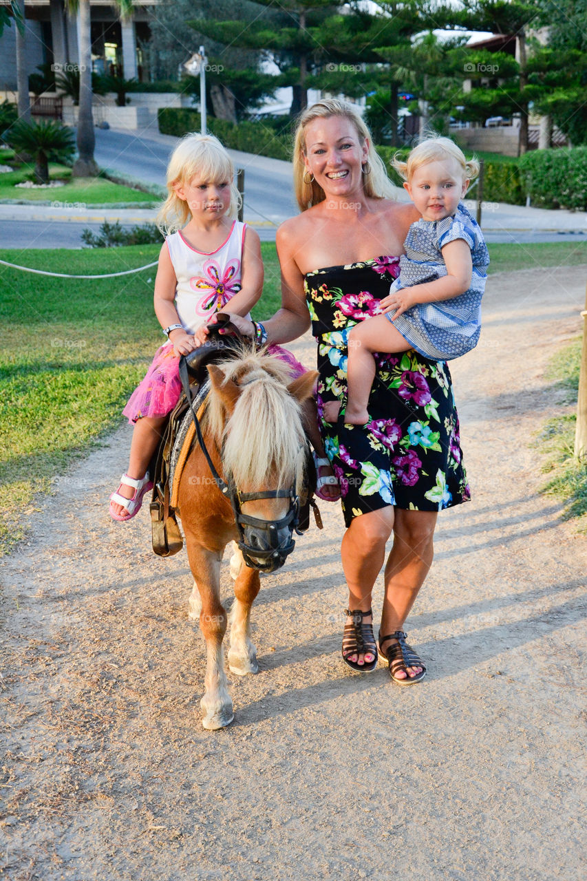 Portrait of a family with horse