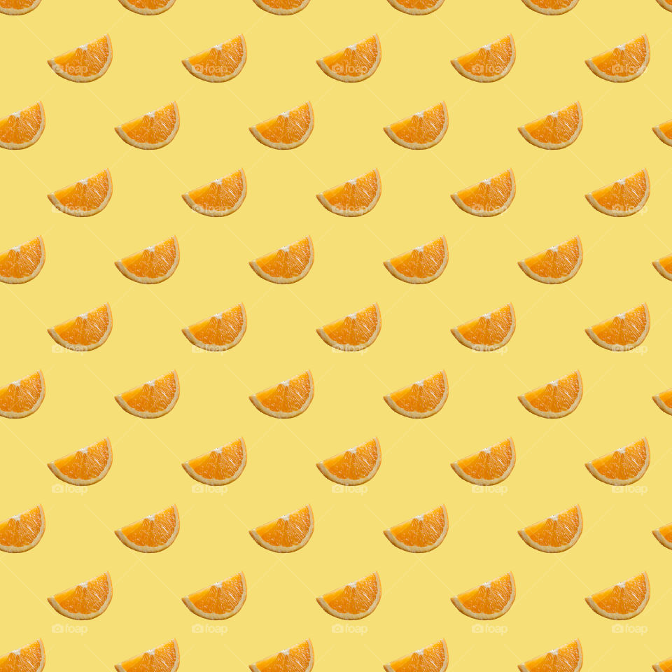 Seamless pattern of orange fruit with yellow background 