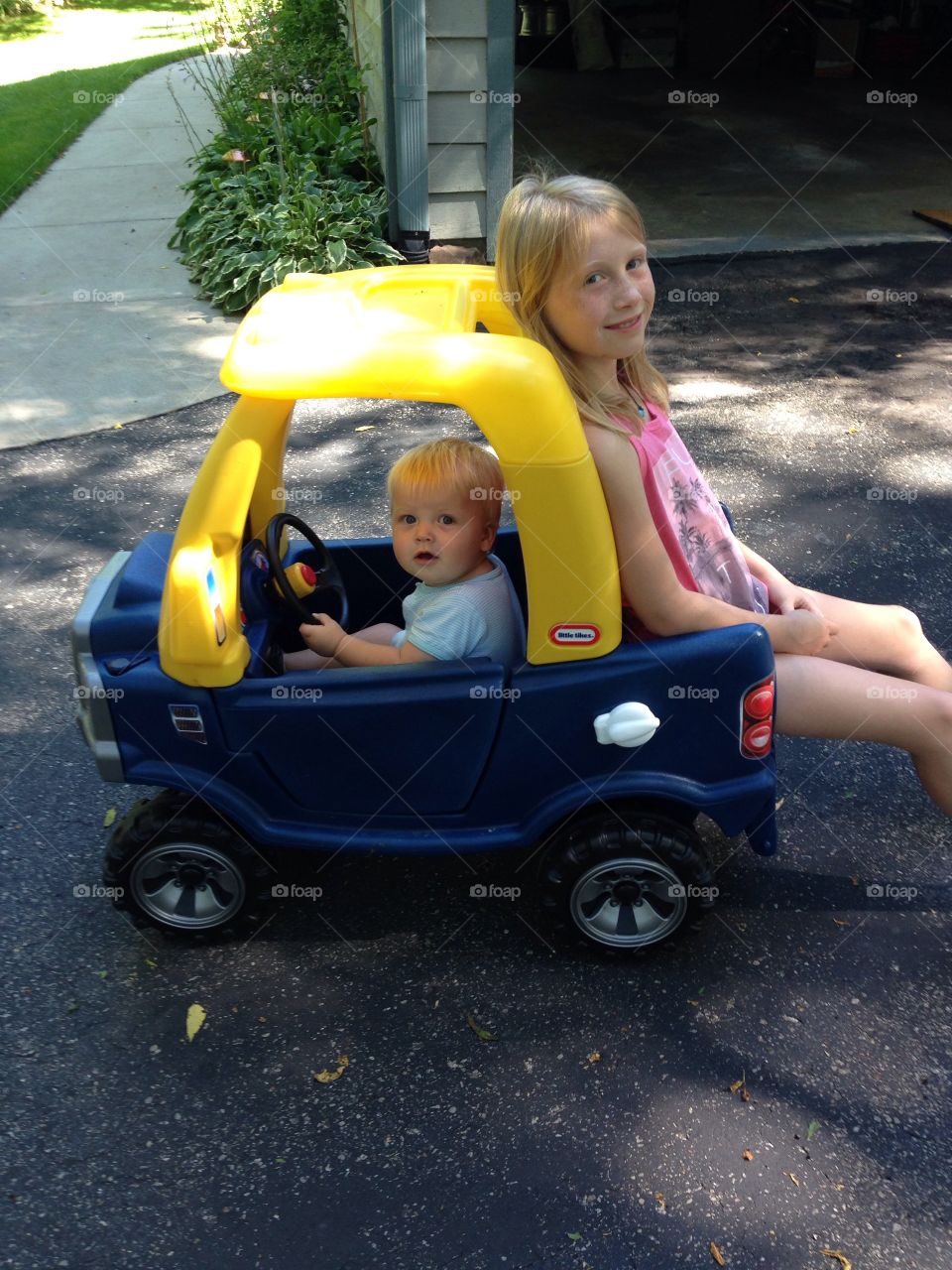 Precious Cargo. Toting around big sis!