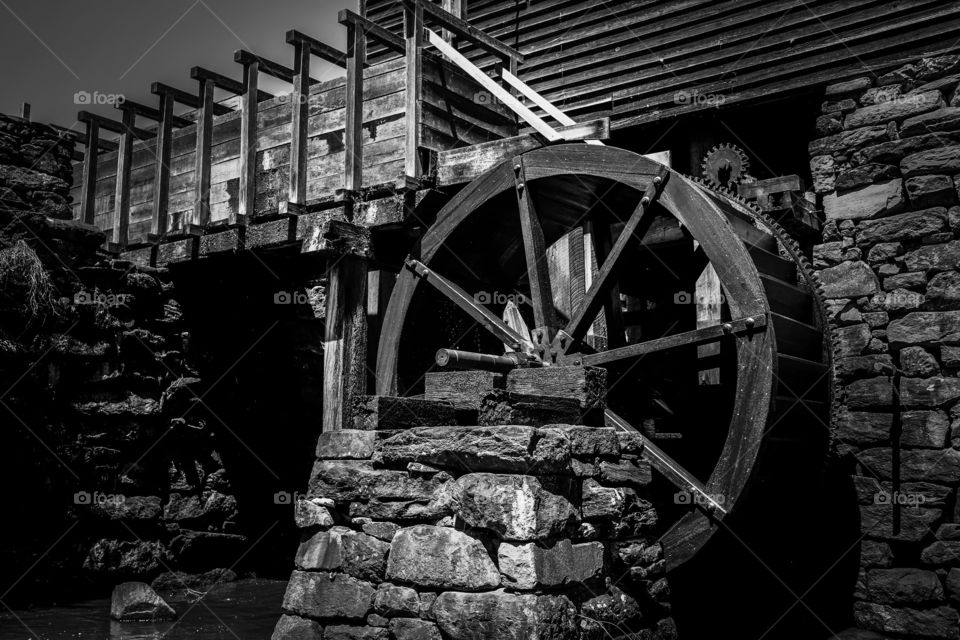 Black and white of the waterwheel and flume at the old watermill or gristmill at Historic Yates Mill County Park in Raleigh North Carolina, Triangle area, Wake County. 