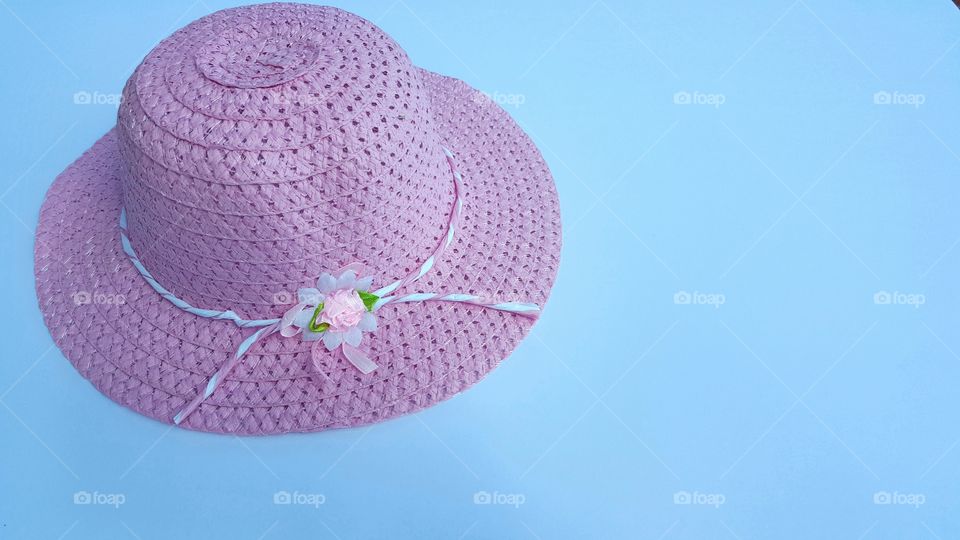 Pink hat against blue background