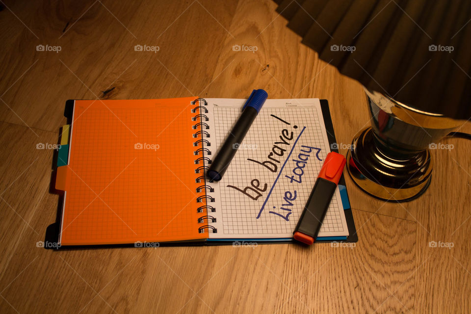 Motivational letter in a notebook on the desktop under the light of a lamp