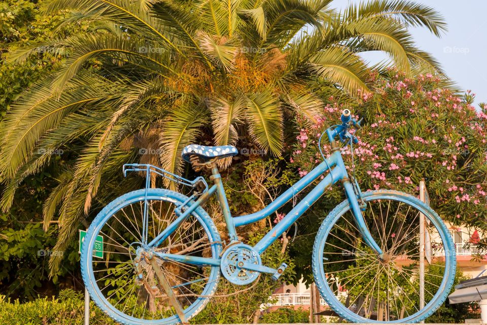 An old blue bike as a street decoration