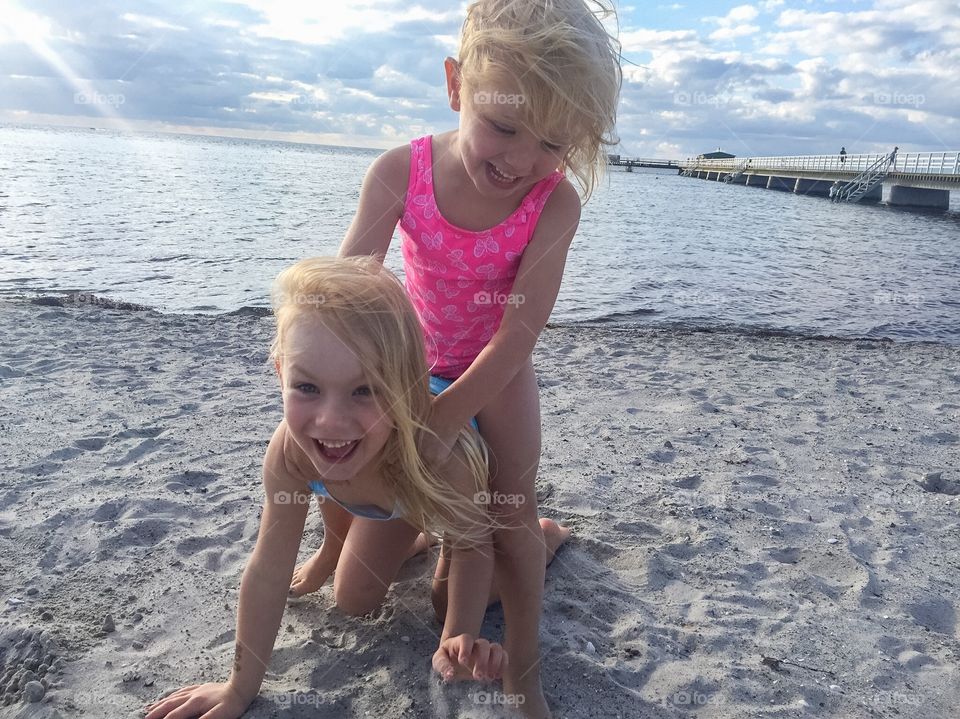 Two sisters are playing on Ribban beach in Malmö Sweden.