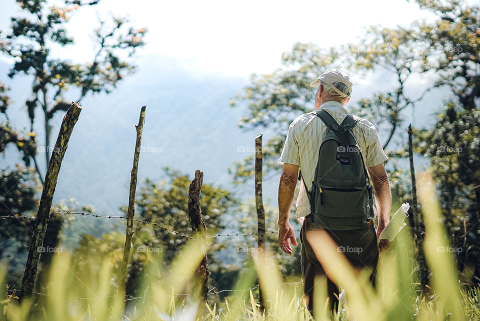 Older man enjoying nature in times of social estating