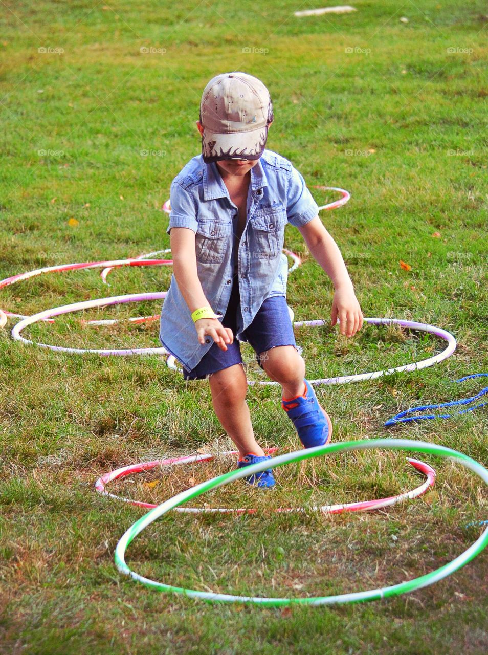 Boy playing. Child playing with hula hoops