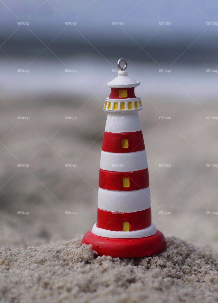 Lighthouse souvenir on the sand beach