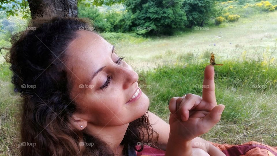 Butterfly lands on a girl's finger