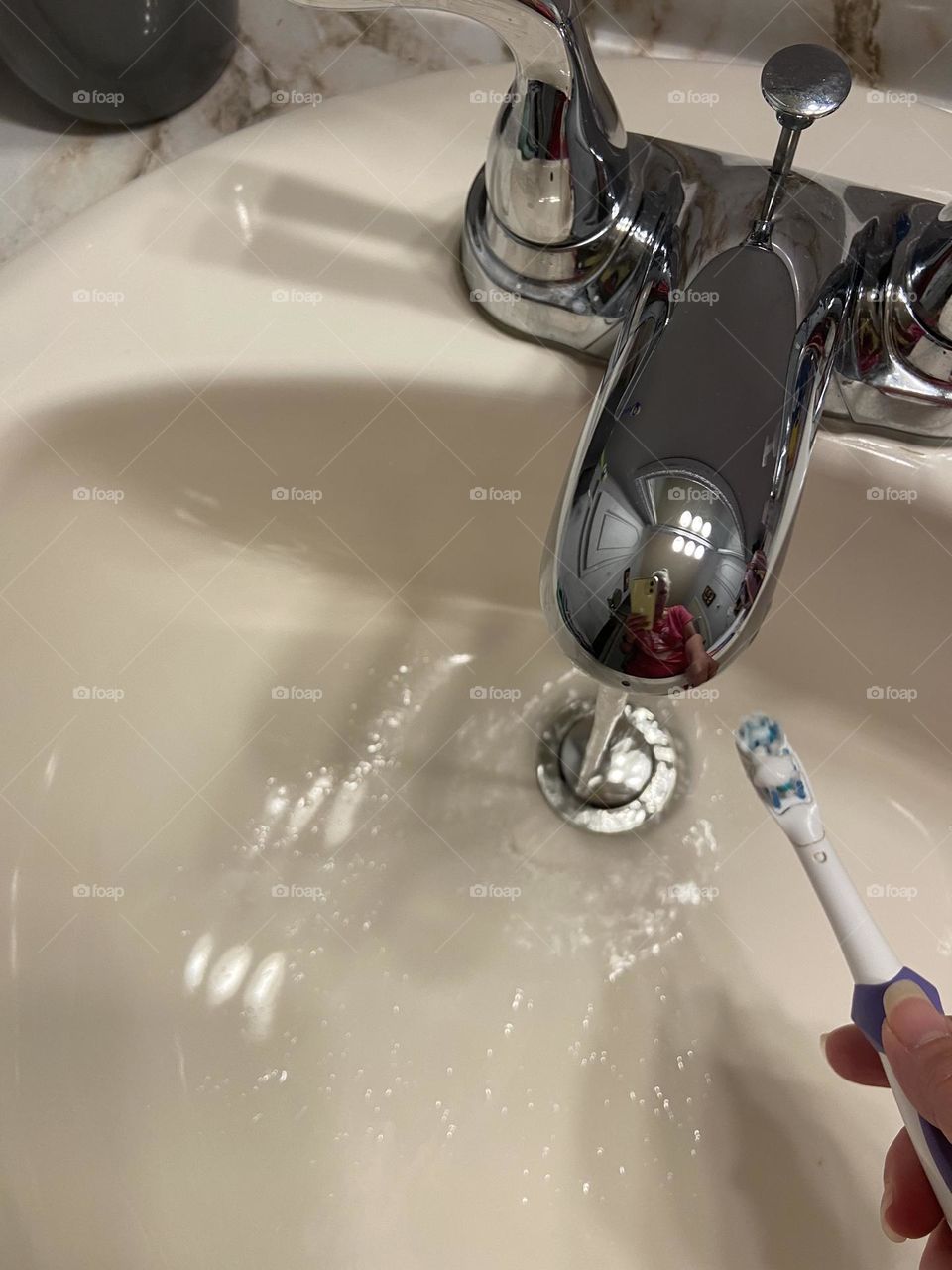 Getting ready to brush my teeth with my favorite toothpaste at the bathroom sink. 