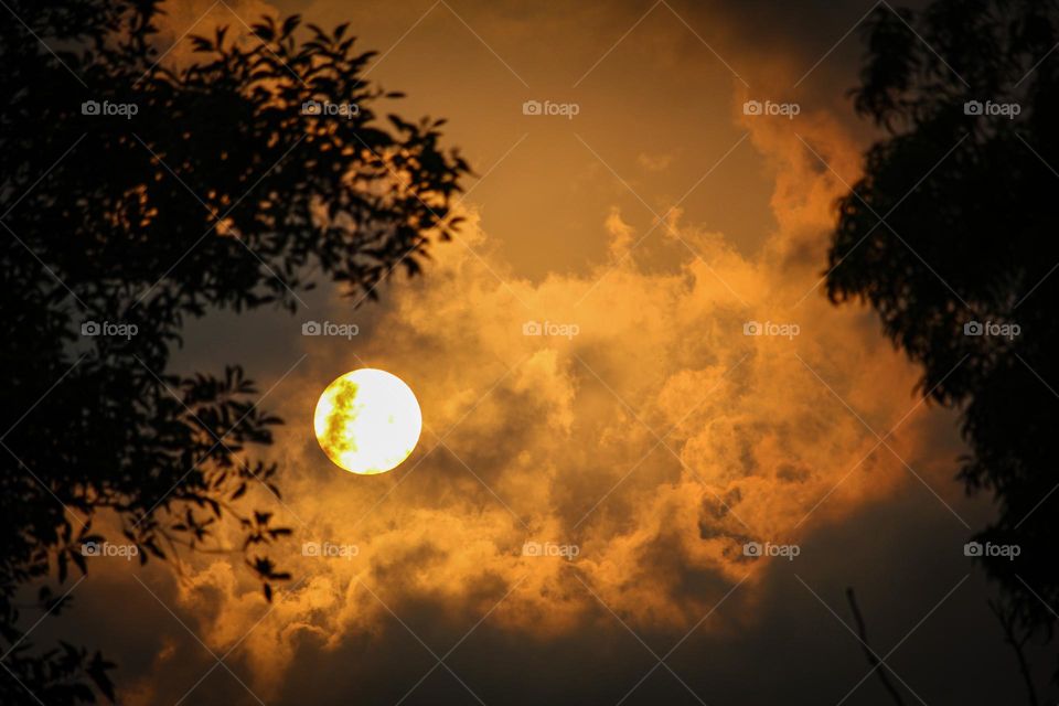 sun behind the clouds