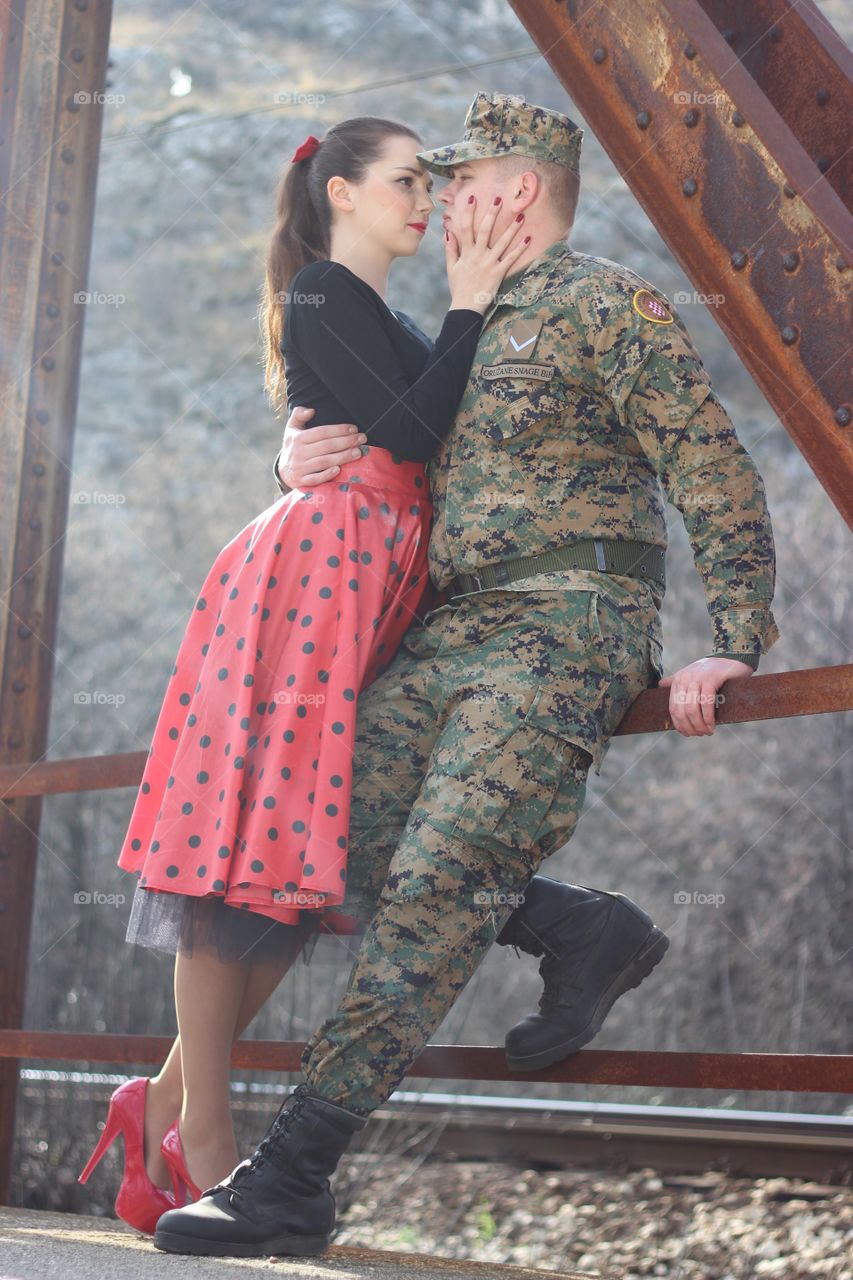 Soldier with his wife on bridge