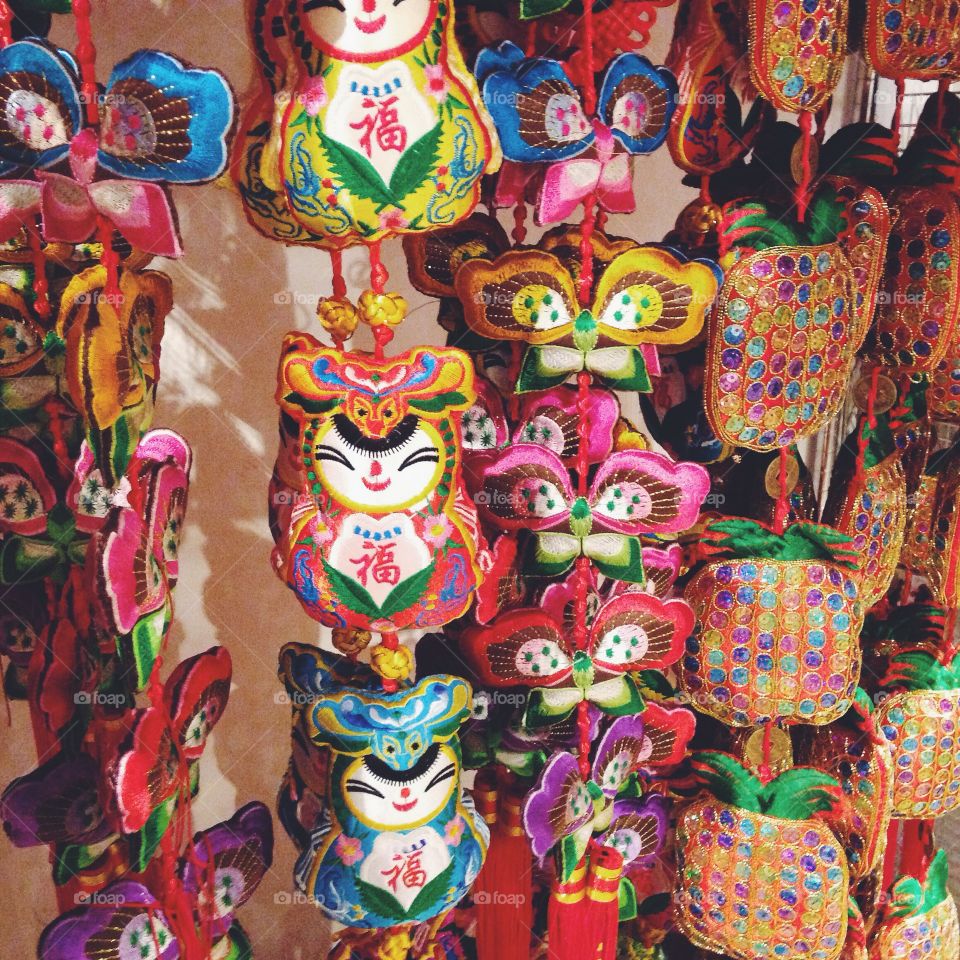 Adorable Chinese New Year Decorations hanging in a shop.