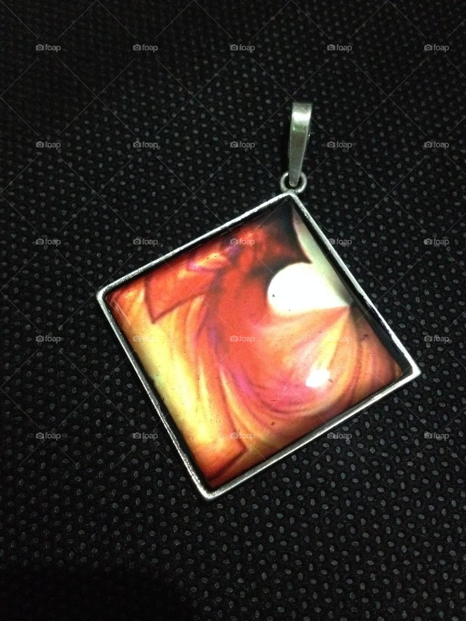 silver pendant with resin encapsulation. jewelry