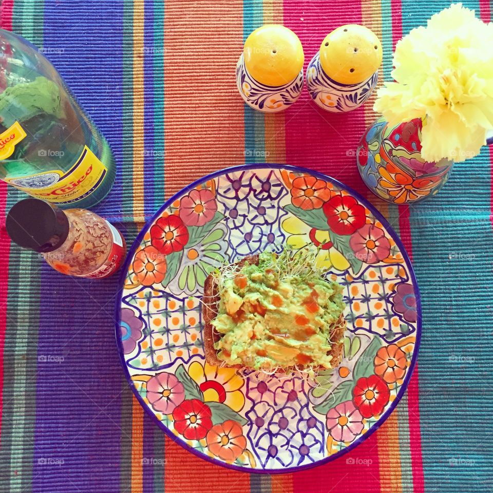 Avocado toast. Smashed avocado, alfalfa sprouts, lime, salt, hot sauce