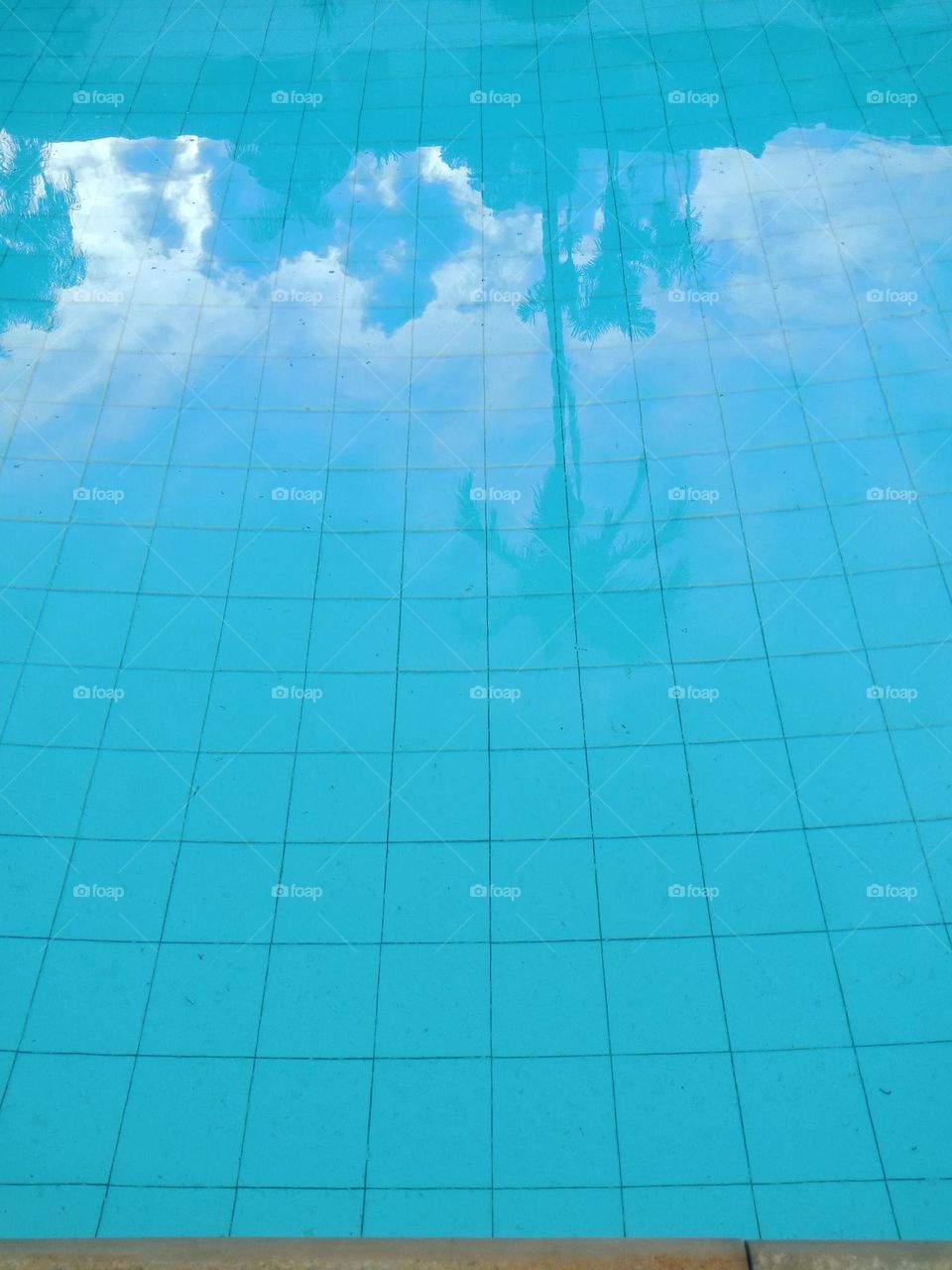 swimming pool with sky reflection