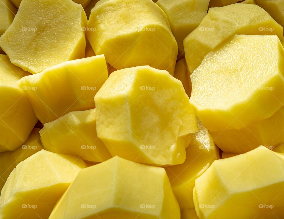 potatoes in a pan on a gas stove burner