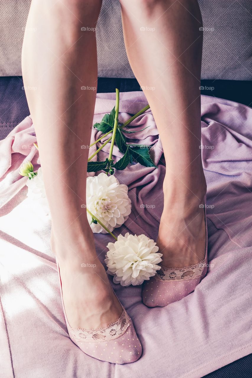 Woman's slim legs in lace pink socks