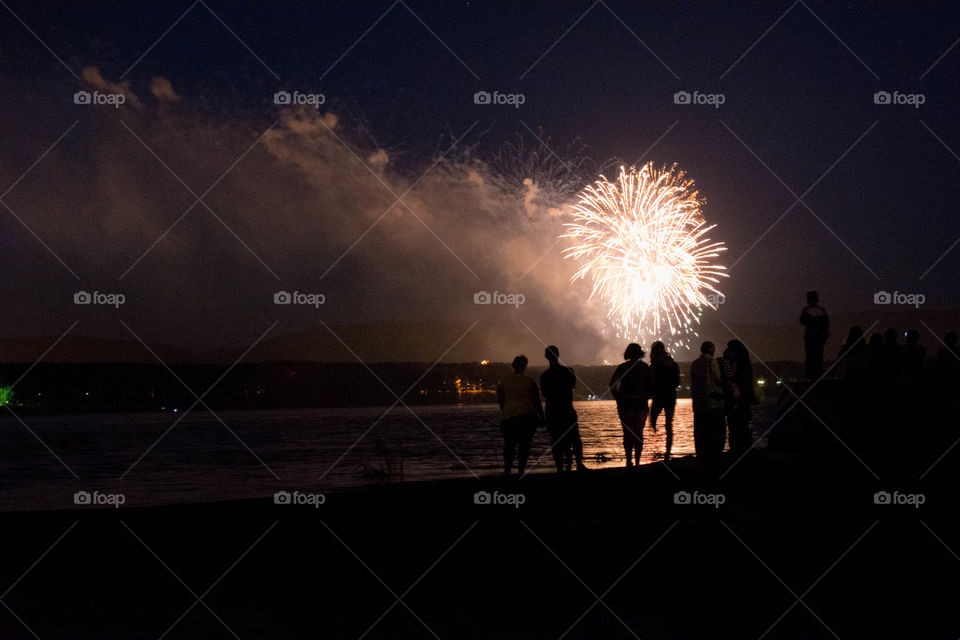 salute. people are watching fireworks