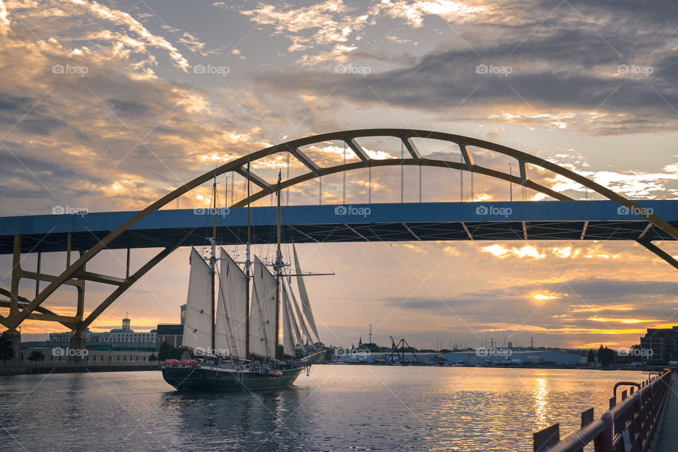 Sunset in Milwaukee Wisconsin over the Hoan bridge with a sailboat