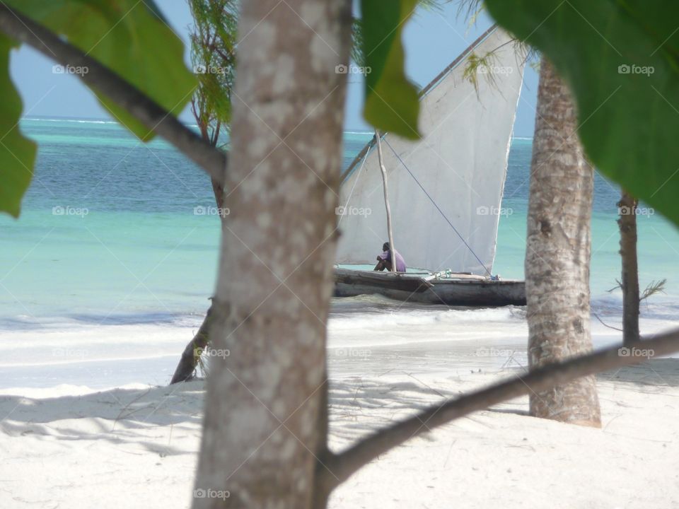 Sail boat on the shore of white beach