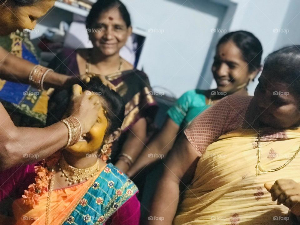 a bridel women surounded by beautifully smiling  women .