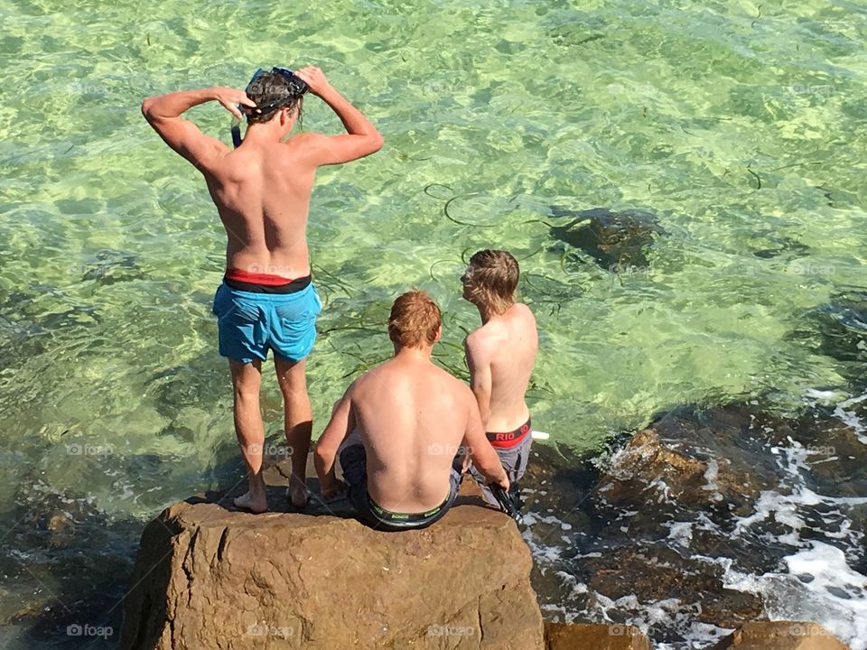 Local youth on rocks by seashore in south Australia 