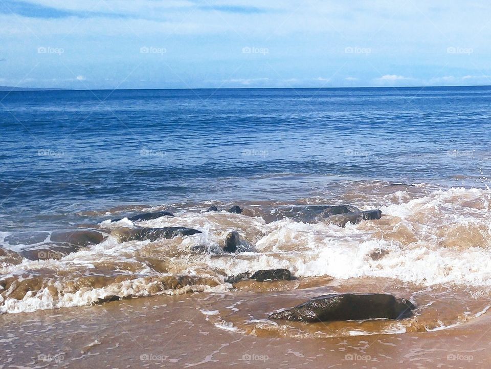 seashore with rocks on windy day