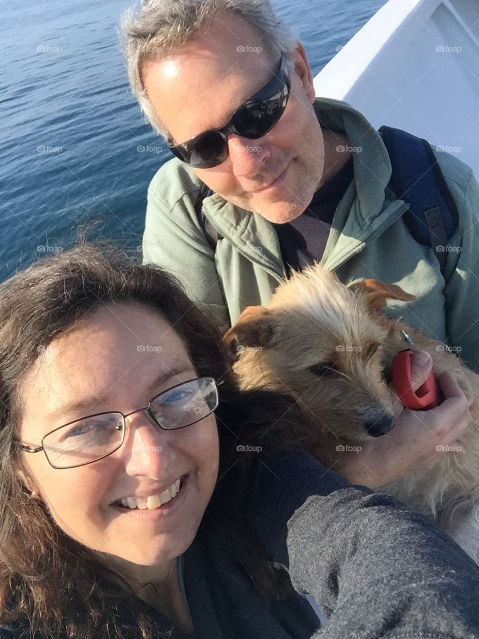 Couple sailing with dog