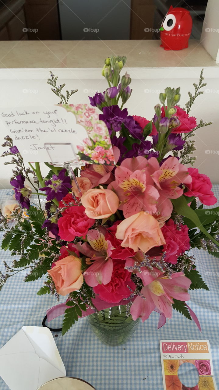 Bouquet of pink and purple flowers with a card