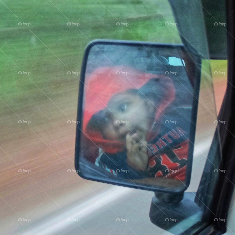 baby portrait looking from a rear view mirror.