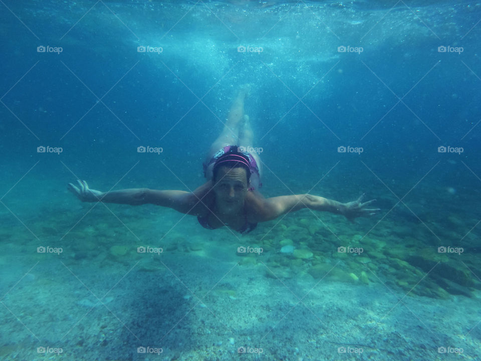 woman diving under the sea. woman diving towards camera underwater