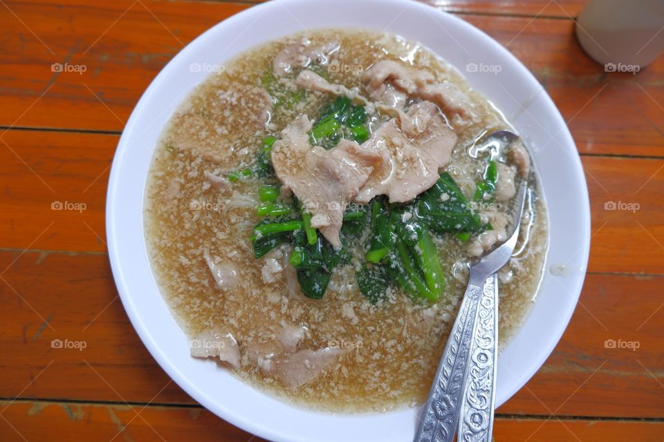 Fried Noodle with Pork in Gravy Sauce,Thai food. It's a noodle dish. Then there will be condiments for people to cook themselves, such as chili, sugar.